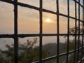 Sunset view through cage Royalty Free Stock Photo