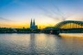 Sunset view of the cathedral in Cologne and Hohenzollern bridge over Rhein, Germany Royalty Free Stock Photo