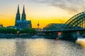 Sunset view of the cathedral in Cologne and Hohenzollern bridge over Rhein, Germany Royalty Free Stock Photo