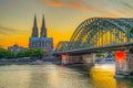 Sunset view of the cathedral in Cologne and Hohenzollern bridge over Rhein, Germany Royalty Free Stock Photo