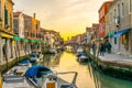 Sunset view of a channel on murano island in italy which is surrounded with tourist shops selling famous murano glass