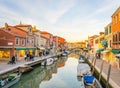 Sunset view of a channel on murano island in italy which is surrounded with tourist shops selling famous murano glass