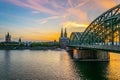 Sunset view of cityscape of Cologne with Hohenzollern bridge, cathedral and Saint Martin church, Germany Royalty Free Stock Photo