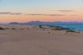 Sunset view of Corralejo sand dunes and Lanzarote from Fuerteventura, Canary islands, Spain Royalty Free Stock Photo