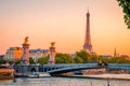 Sunset view of  Eiffel Tower, Alexander III Bridge and river Seine in Paris, France Royalty Free Stock Photo