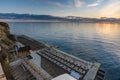 Sunset view on an empty sunlounge beach on a rocky sea shore