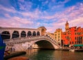 Sunset view of famous bridge of Rialto or ponte di Rialto over Grand Canal, Venice, Italy. Iconic travel destination of