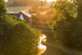 Sunset view flying midges over British rural landscape scene with river near Northampton