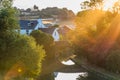 Sunset view flying midges over British rural landscape scene with river near Northampton