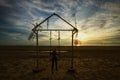 Sunset view a girl playing swing at beach Royalty Free Stock Photo