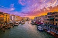 Sunset view of Grand Canal, Venice, Italy. Vaporetto or waterbus station, boats, gondolas moored by walkways, beautiful