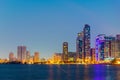 Sunset view of the Khalid lagoon surrounded with skyscraper in the emirate Sharjah, UAE