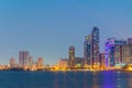 Sunset view of the Khalid lagoon surrounded with skyscraper in the emirate Sharjah, UAE