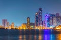 Sunset view of the Khalid lagoon surrounded with skyscraper in the emirate Sharjah, UAE