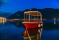 Sunset view of Kotor Bay, mountains and a docked boat in the postcard perfect town of Perast, Montenegro, long exposure