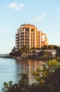 Sunset view of the La Bellasara Condos on the sea coast in Sarasota, Florida, with a wooden dock