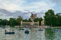 Sunset view in the Lake of El Retiro Park where many visitors sail with their boats on a beautiful afternoon.