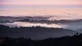 Sunset view of layered hills and valleys covered by a sea of clouds in Santa Cruz mountains ; San Francisco bay area, California Royalty Free Stock Photo