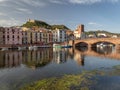 Sunset view at medieval city Bosa with river and houses reflected in Temo river