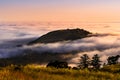 Sunset view of mountain top rising up above a sea of clouds in the Santa Cruz mountains; San Francisco bay area, California Royalty Free Stock Photo