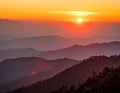 Fiery sunset above layered mountain ridges in Sarangkot, Nepal. The sun sets over mis Royalty Free Stock Photo