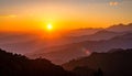 Fiery sunset above layered mountain ridges in Sarangkot, Nepal. The sun sets over mis Royalty Free Stock Photo