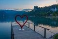 Sunset view over a romantic pier at lake Bled in Slovenia Royalty Free Stock Photo