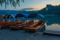 Sunset view over rowing boats looking at Bled castle in Slovenia Royalty Free Stock Photo