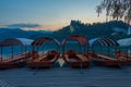 Sunset view over rowing boats looking at Bled castle in Slovenia Royalty Free Stock Photo