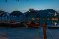 Sunset view over rowing boats looking at Bled castle in Slovenia Royalty Free Stock Photo