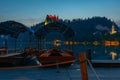 Sunset view over rowing boats looking at Bled castle in Slovenia Royalty Free Stock Photo