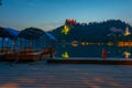 Sunset view over rowing boats looking at Bled castle in Slovenia Royalty Free Stock Photo