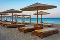 Sunset view of parasols and sunbeds at Vai beach at Crete, Greec Royalty Free Stock Photo