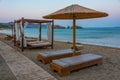 Sunset view of parasols and sunbeds at Vai beach at Crete, Greec Royalty Free Stock Photo