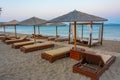 Sunset view of parasols and sunbeds at Vai beach at Crete, Greec Royalty Free Stock Photo