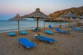 Sunset view of parasols and sunbeds at Vai beach at Crete, Greec Royalty Free Stock Photo