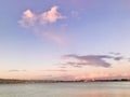 Sunset view with pink clouds and blue sky at the coast. Royalty Free Stock Photo