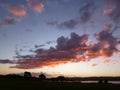 Sunset view with red clouds and blue sky at the coast. Royalty Free Stock Photo