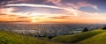 Sunset view of residential and industrial areas in East San Francisco Bay Area; green hills visible in the foreground; Hayward, Royalty Free Stock Photo