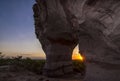 Sunset view through the rock. Arenite hole, in Jalapao, Brazil. Pedra furada. Royalty Free Stock Photo