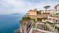 Sunset view of rocky seafront with hotels in Sorrento, Italy