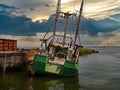 Sunset view of a rusting and abandoned fishing trawler