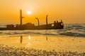 Sunset view of a rusty shipwreck in HaBonim Beach