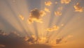 Sunset view with scattered clouds and sun rays extending through, creating a Royalty Free Stock Photo