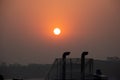 Sunset view from a ship rooftop with ship exhaust pipe silhouette. Sky horizon and sunset close-up view at dusk time. Traveling Royalty Free Stock Photo