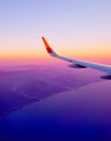 Sunset view of sky and clouds from window of aircraft flight Royalty Free Stock Photo