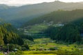 Sunset view with sun rays over countryside mountains, rice field Royalty Free Stock Photo