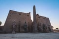 Sunset View to the Illuminated Stone Statues of the large Ancient Egyptian temple in Luxor Royalty Free Stock Photo