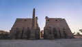 Sunset View to the Illuminated Stone Statues of the large Ancient Egyptian temple in Luxor Royalty Free Stock Photo