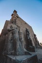 Sunset View to the Illuminated Stone Statues of the large Ancient Egyptian temple in Luxor Royalty Free Stock Photo